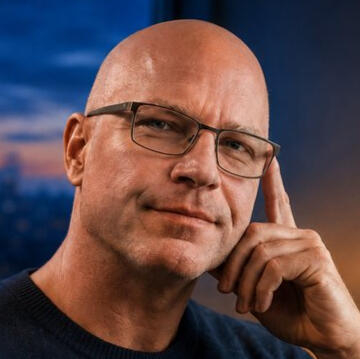 Portrait of Jeff Emmerson Head-and-shoulders portrait of Jeff Emmerson wearing glasses and a dark shirt.