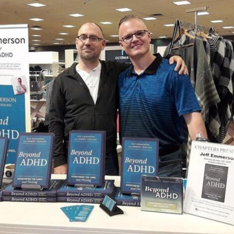 Jeff Emmerson at a Beyond ADHD Book Signing Jeff Emmerson at a book signing for Beyond ADHD: Overcoming the Label and Thriving, standing behind a table displaying copies of the book.